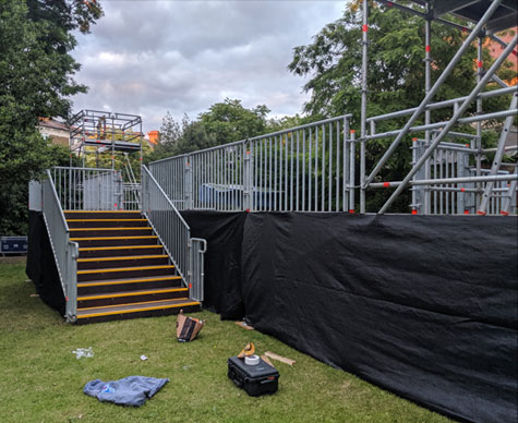 Outdoor tiered seating with camera towers.